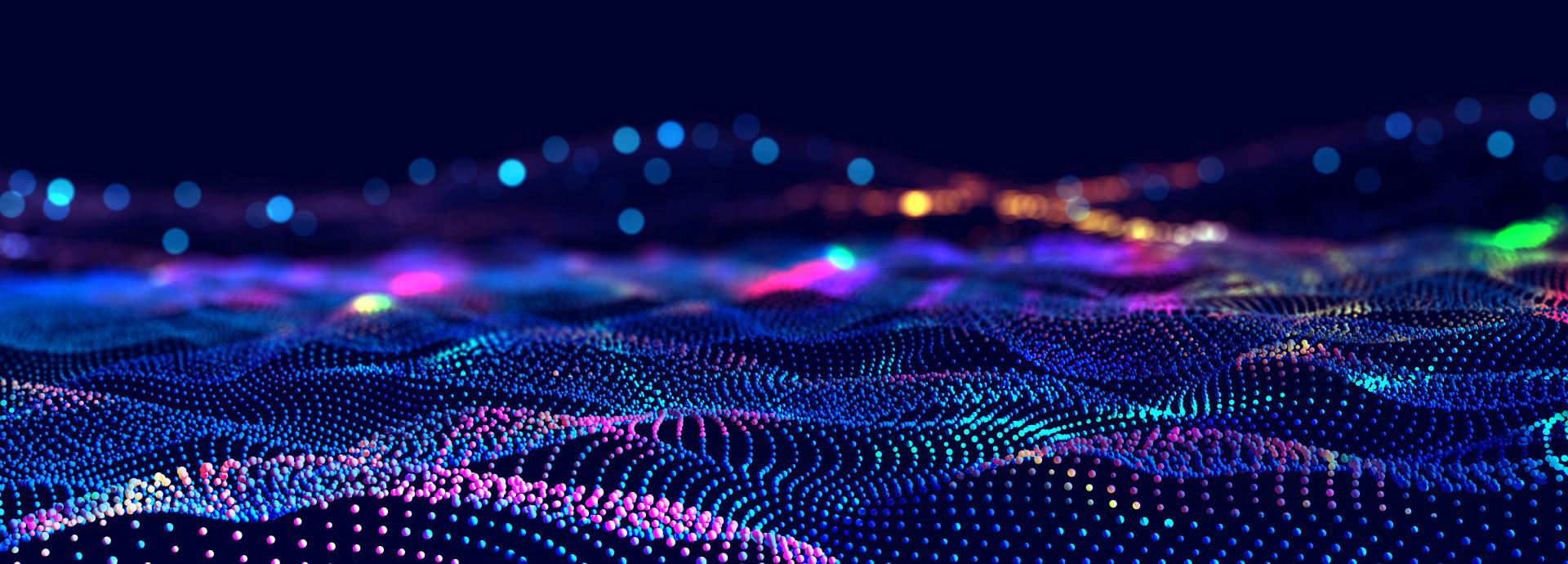 This image displays a digital landscape of multicolored, glowing dots arranged in flowing, wave-like patterns. The dots form a dynamic and futuristic grid, with vibrant hues of blue, pink, purple, and green fading into the background.