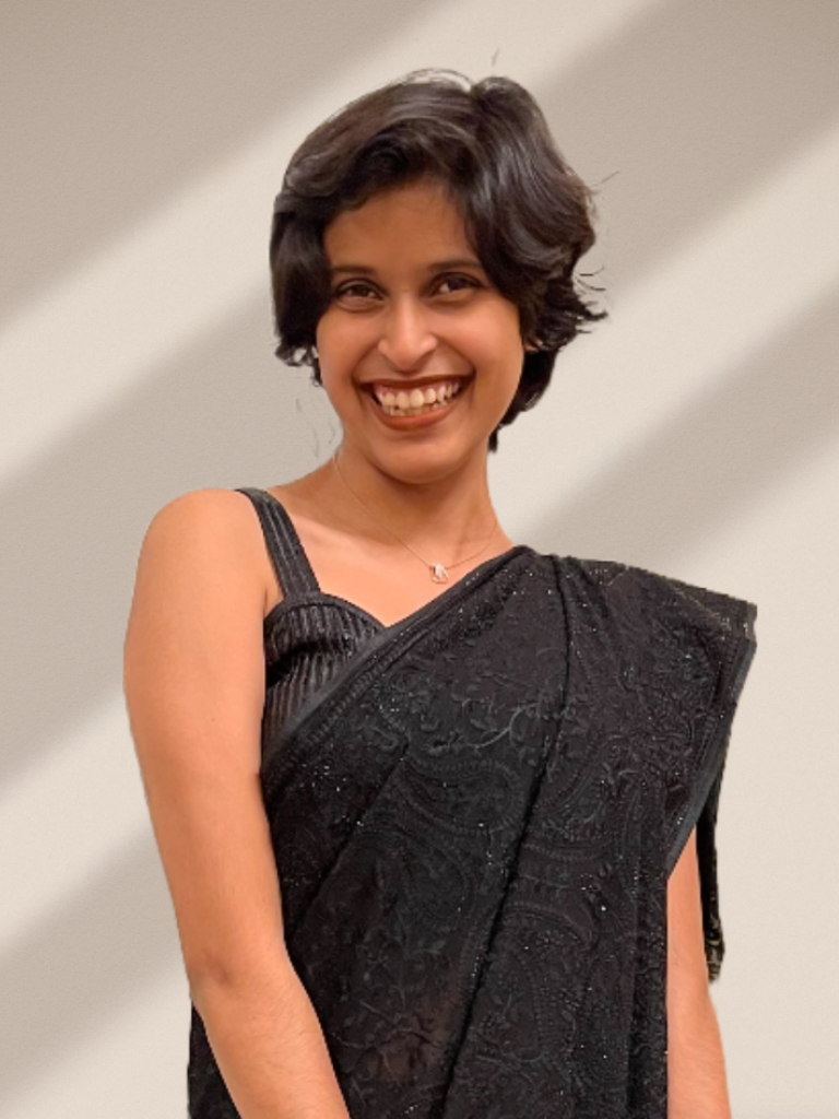 Brown woman with short hair wearing black sari