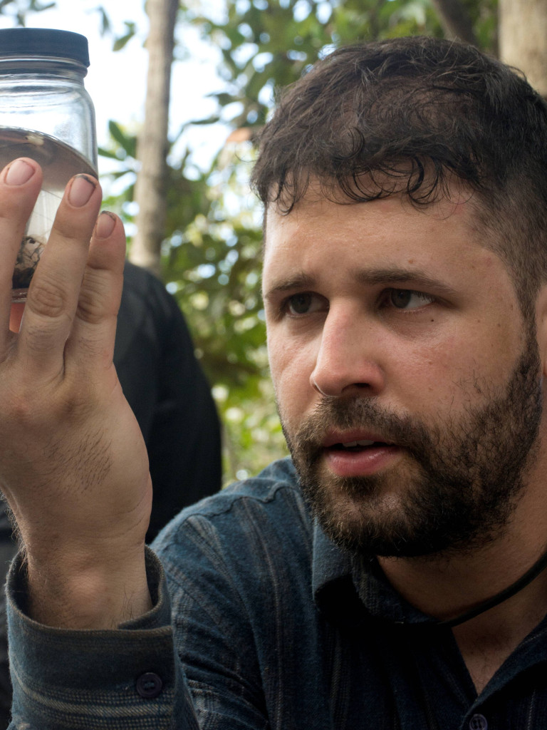 Dr. Bernardo Santos looks at a sample during a field trip