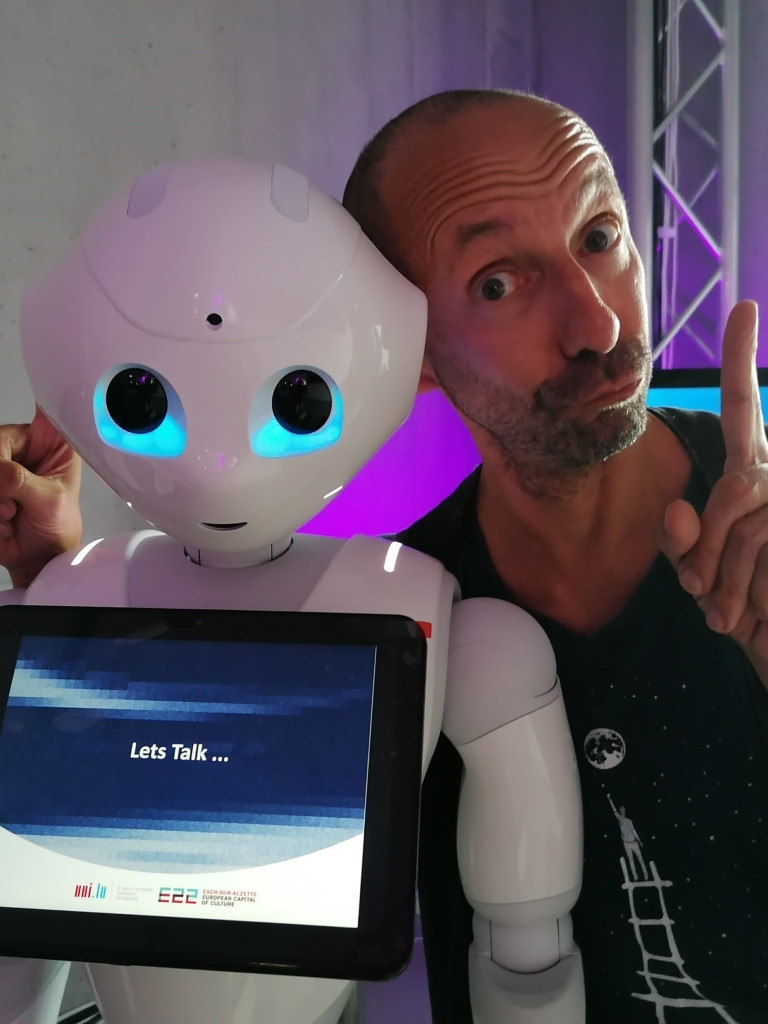 TeeKay and a robot ask for your attention 