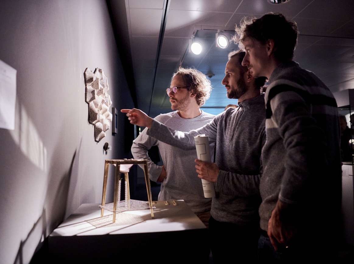 A shot of people looking at artworks inside an exhibition
