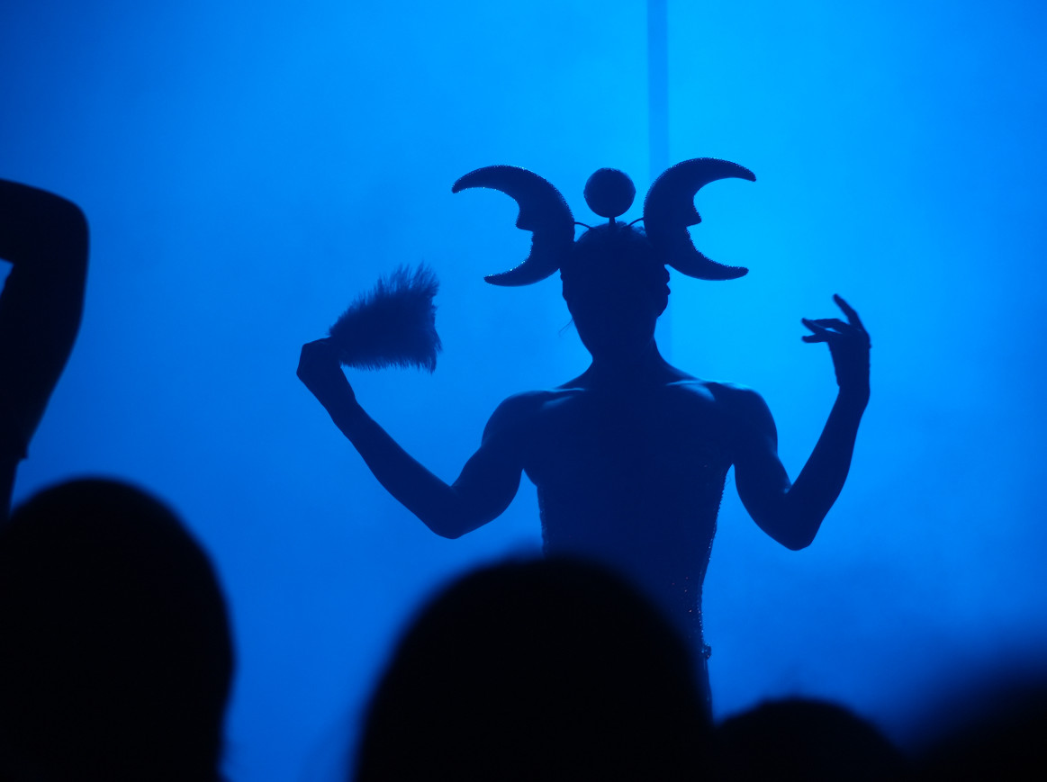 A performer wearing a headdress captured with backlight