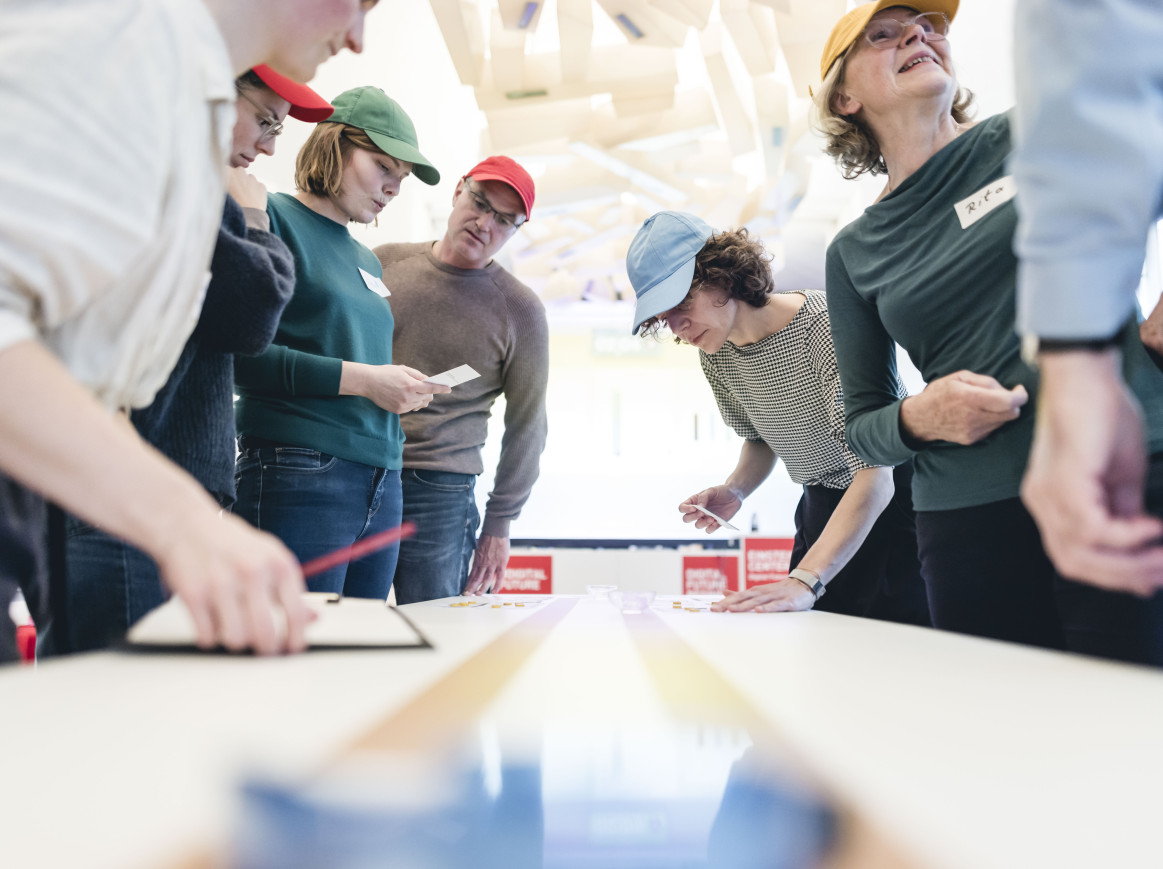 Shot of people around a table, playing a game