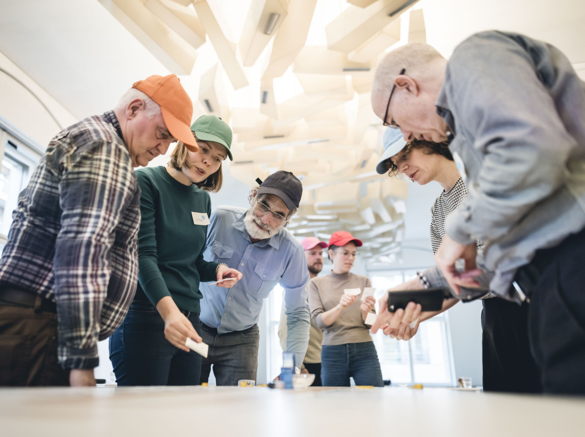 Shot of people around a table, playing a game