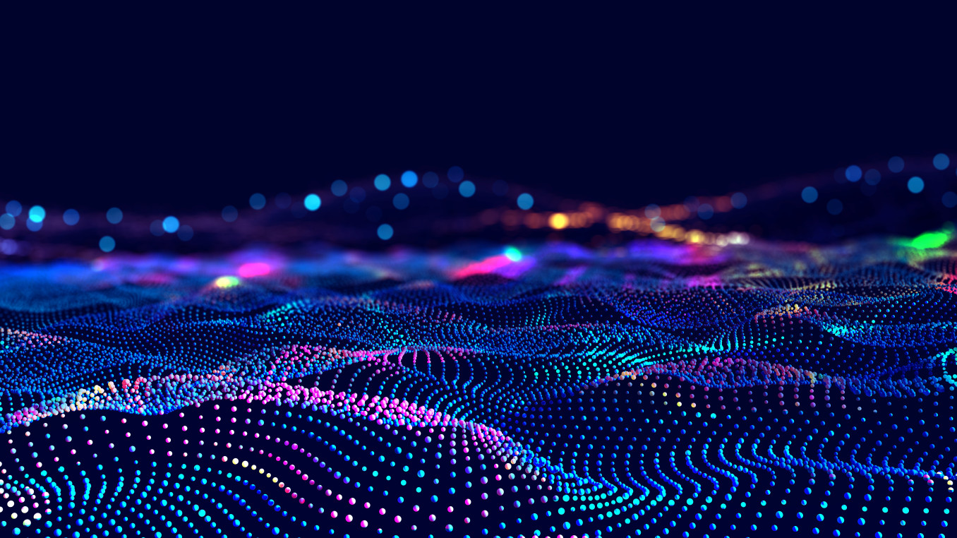 This image displays a digital landscape of multicolored, glowing dots arranged in flowing, wave-like patterns. The dots form a dynamic and futuristic grid, with vibrant hues of blue, pink, purple, and green fading into the background. 