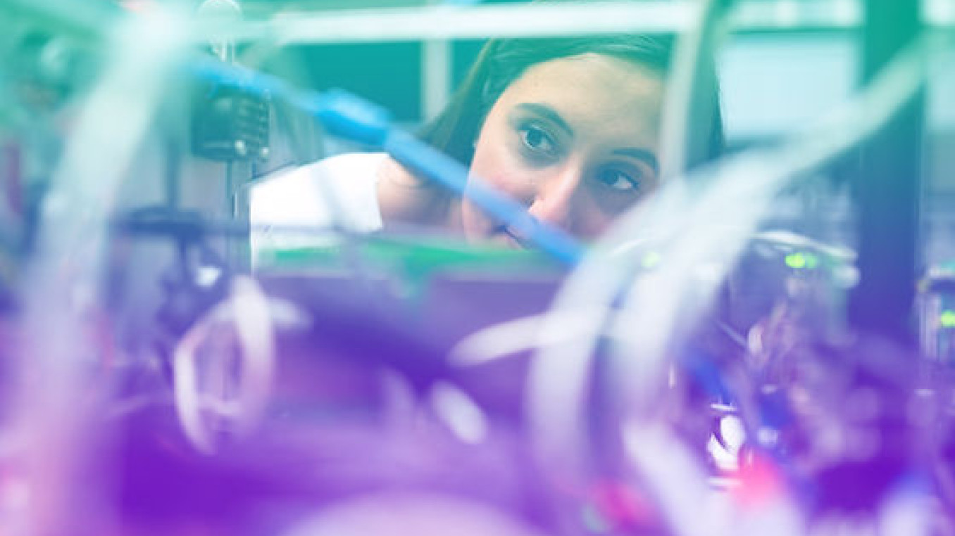 A woman looking at a circuit