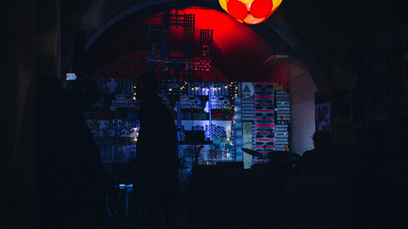 A  stage before a concert in a dark room.
